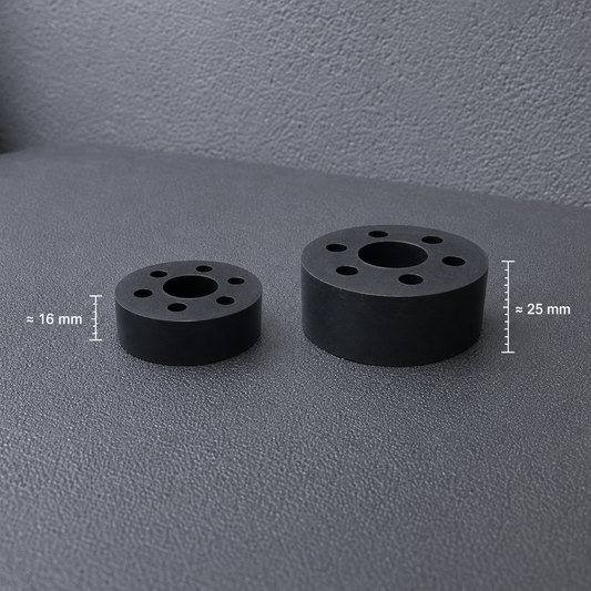Two black circular cylindrical components with multiple holes, shown on a textured gray surface with dimension labels indicating 16 mm and 25 mm.